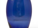 a blue glass vase with a gold rim on a white background