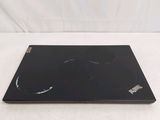 a black laptop with a broken screen on a white surface