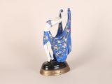 figurine of a woman in a blue dress holding a fan