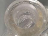 a clear glass object with a hole in the middle of it