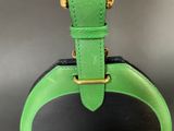the green and black bag is sitting on top of the table