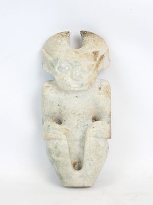 an image of a stone figurine of a man with a hat on it ' s head