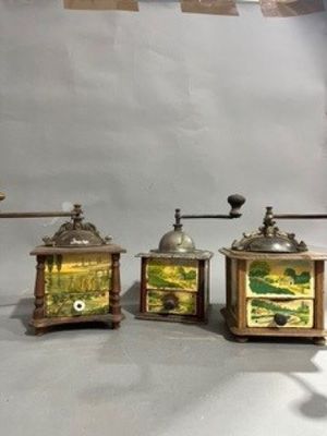 three different types of coffee grinders on a table