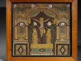 a small mosaic painting of jesus on the cross in a wooden frame