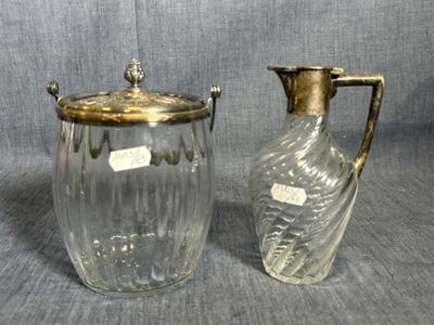 pair of glass and brass vases with handles on a gray background