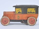 an old fashioned toy car that is sitting on a white surface