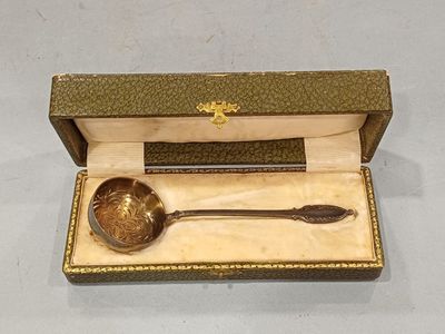 a gold spoon and a spoon rest in a box