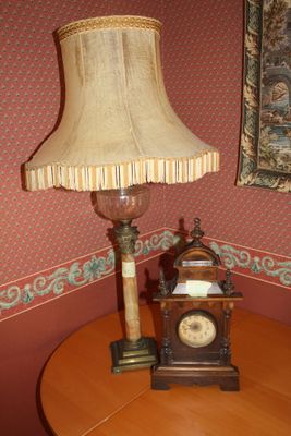 a table with a lamp and a clock on it