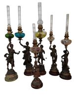 Réunion de 6 lampes à pétrole à fut sujet en régule.