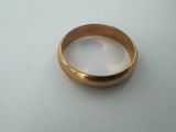 a close up of a gold ring on a white surface