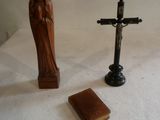 a statue of a woman and a cross on a table