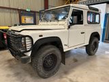 a picture of a white land rover parked in a garage