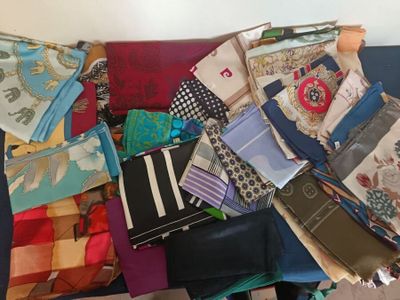 many different types of ties laid out on a couch
