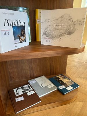 two books on a wooden shelf next to each other