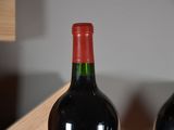 two bottles of wine sitting on a table next to each other