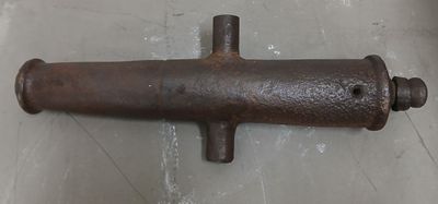 an old rusted pipe on the floor in the room