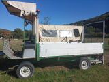 a small truck with a tent on the back of it