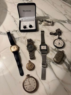 a lot of watches that are sitting on a table