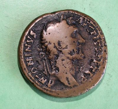 a close up of a coin on a green surface