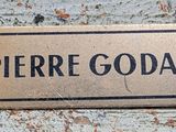 a sign that says pierre godar on the side of a building