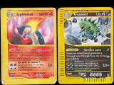 four pokemon cards are lined up in a row on a black background