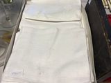 a stack of folded white napkins on a table
