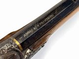 an old gun that is on display on a white surface