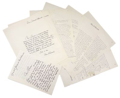 several old letters are stacked on top of each other on a white surface