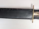 a knife that is laying on a white surface