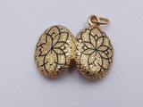 two gold heart shaped lockes sitting on top of a white surface