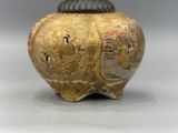 an image of a gold vase sitting on top of a white table