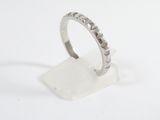 sterling silver ring with diamonds on a clear acrylic stand