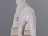 a white statue of a dog on a table