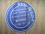 a blue sign on the side of a wooden wall