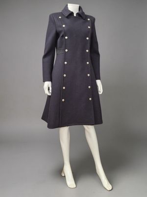 a mannequin dress and coat with buttons on a mannequin mannequin mannequin mann