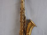the saxophone is sitting on a white surface with a white background