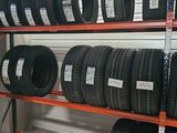 tires on a shelf in a tire store for sale