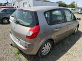 a silver car parked in a lot with other cars in the background