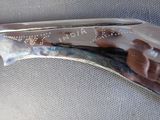 a knife with a fish on it sitting on a table