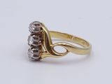 a close up of a gold ring with diamonds on a white background
