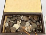 une boîte remplie de pièces de monnaie posée sur une table