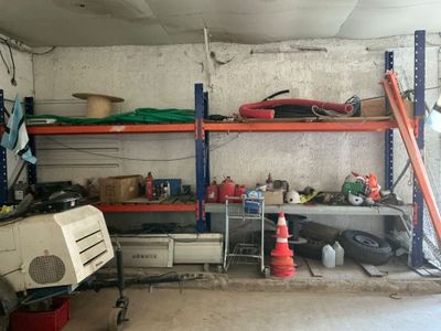 an image of a garage with a lot of things on the shelves