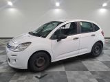 a picture of a small white car parked in a garage