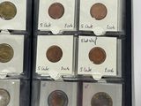 a lot of coins in a case with labels on them