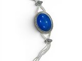 a close up of a necklace with a blue stone on it