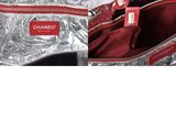 a silver bag with a red tag on it