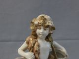 a figurine of a girl with a basket on a table