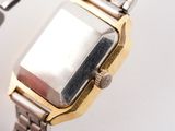 a close up of a watch with a metal band