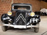 an old car that is parked in a garage