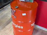 a large orange barrel with magazines on top of it